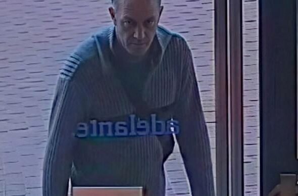 Hombre entrando por la puerta sospechoso de crimen Barcelona.