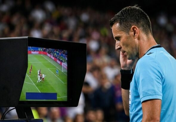 Un árbitro revisando una jugada en el monitor del VAR.