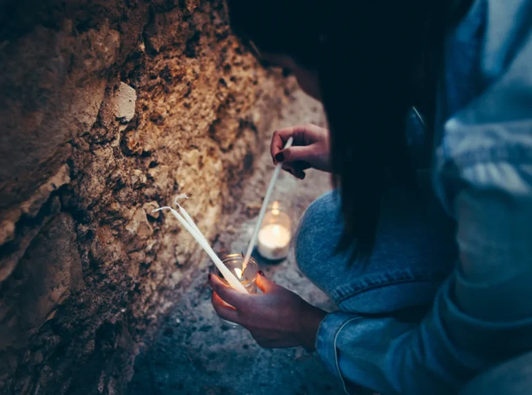 Imagen que muestra una chica encendiendo velas en Pedraza para el concierto